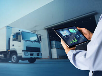 Man hand using digital tablet on blurred delivery truck as background